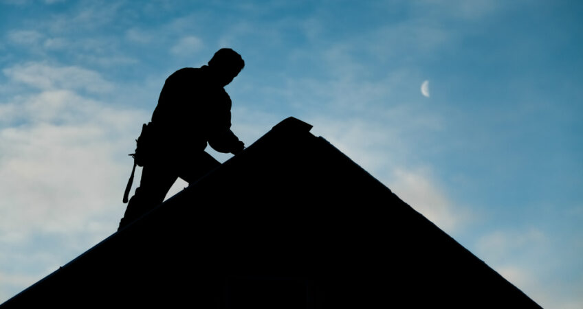 man repairing roof